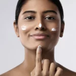 A woman using face product