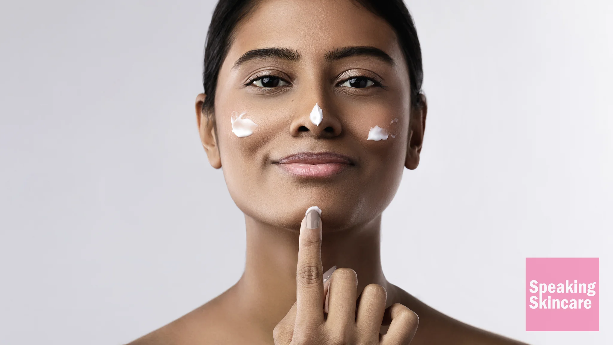 A woman using face product