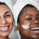 Two women using face cream