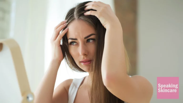 A woman scratching her head