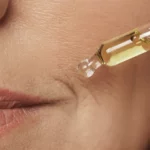 An older woman using serum.
