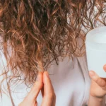 A woman using hair product