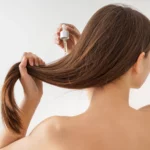 A woman using hair serum