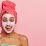 A woman wearing a clay mask