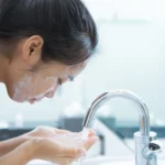 A woman washing her face