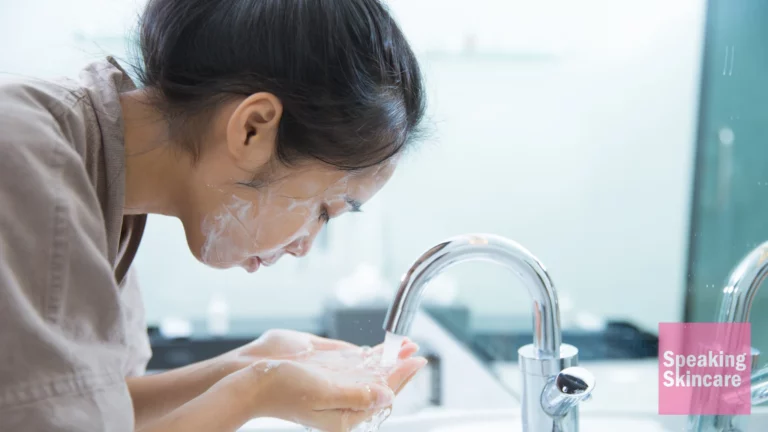 A woman washing her face