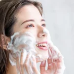 A woman washing her face