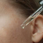 A woman using a serum