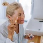 An older woman using products