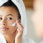 A woman using product on face