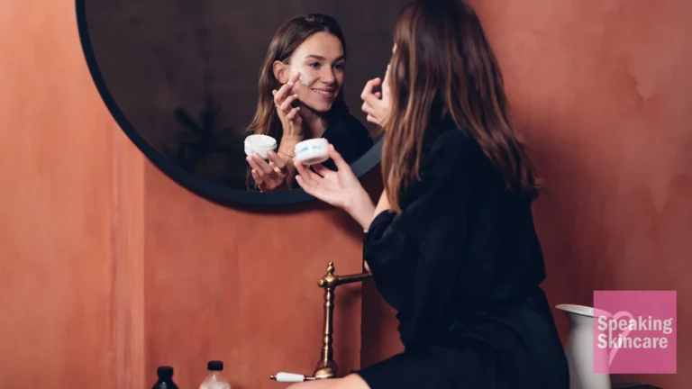 A woman applying moisturiser