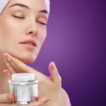 A woman applying face cream
