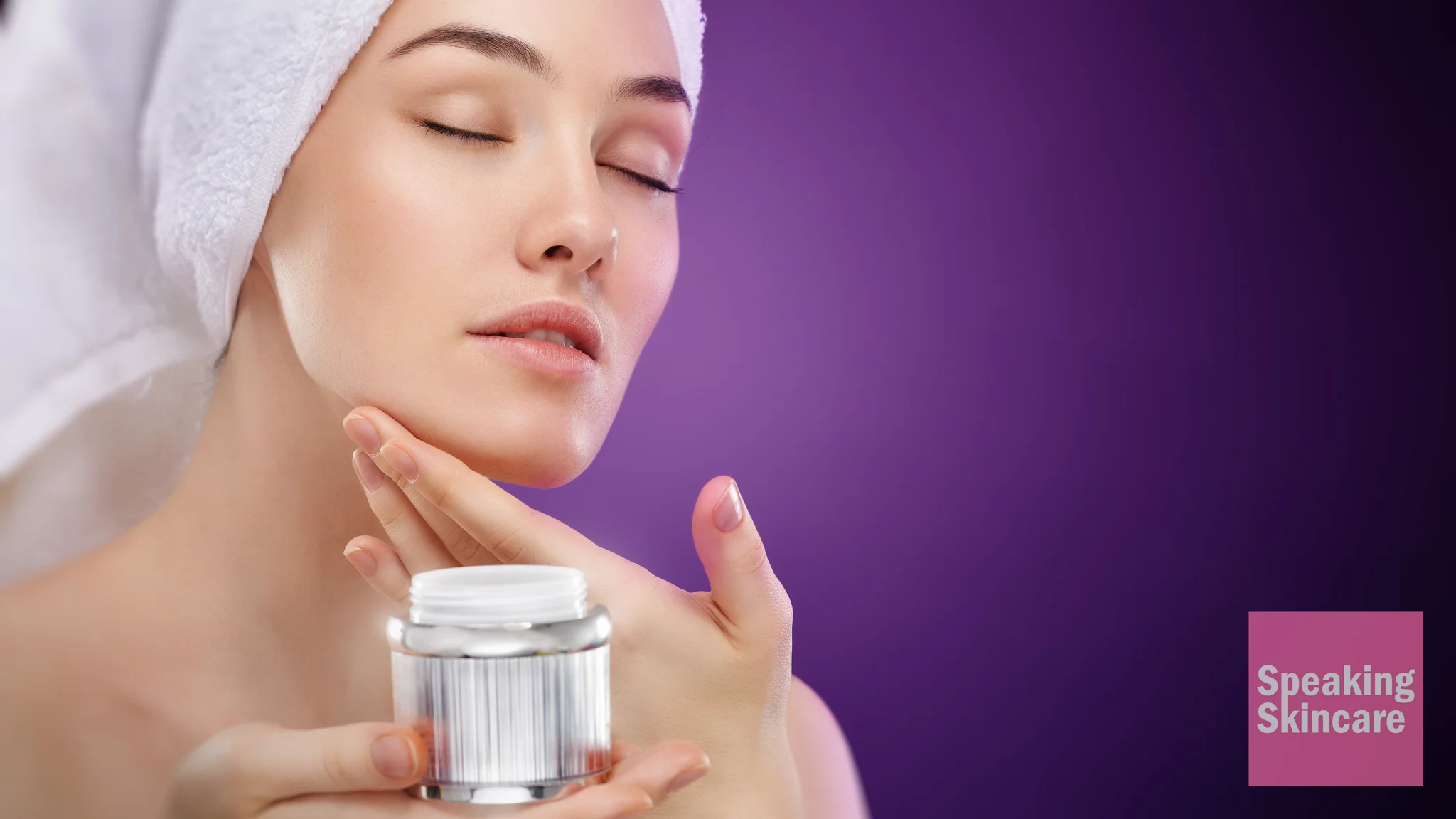 A woman applying face cream