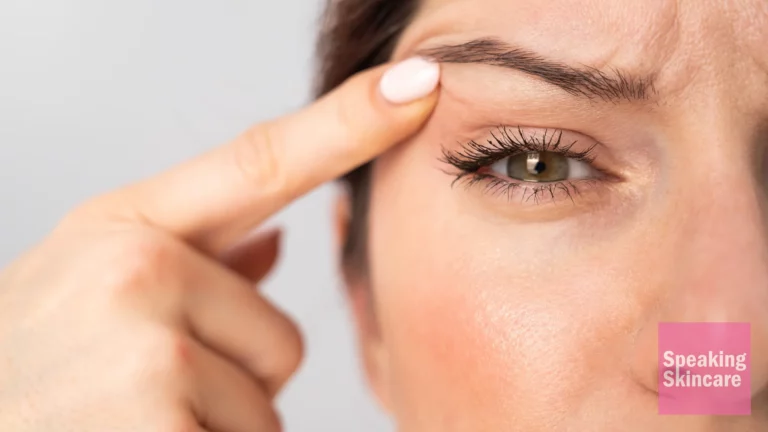 A woman pointing at her eyes