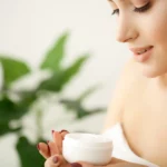 A woman holding a cream