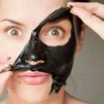 Woman peeling off mask