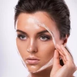 A woman peeling off a mask