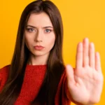 A woman holding up her hand