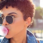 A woman blowing gum
