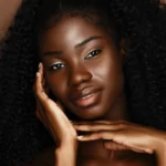 A black woman with shiny skin