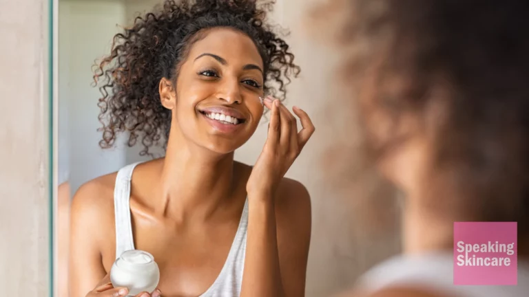 A woman applying face cream