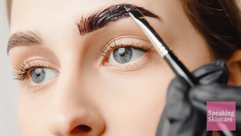 A woman applying eyebrow product