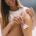 Woman shaving her legs