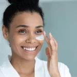 Woman using eye cream