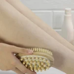 A woman brushing her legs