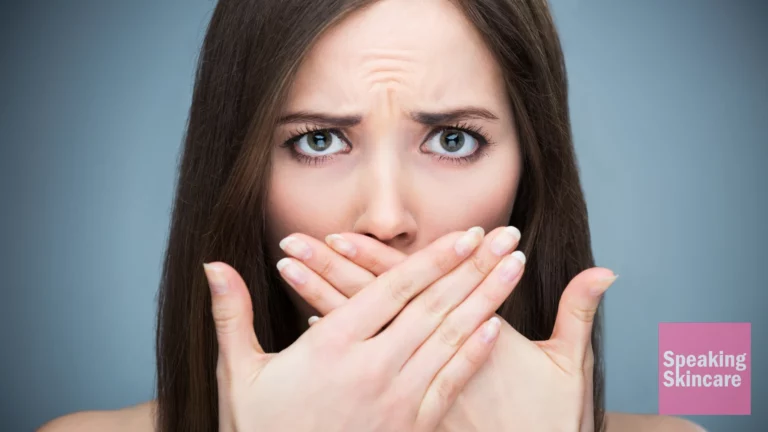 A woman covering her mouth.